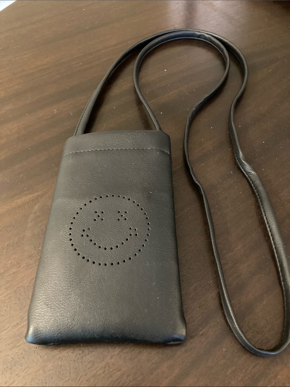 NWOT Black Crossbody Cell Phone Pouch with Perforated Smile Design